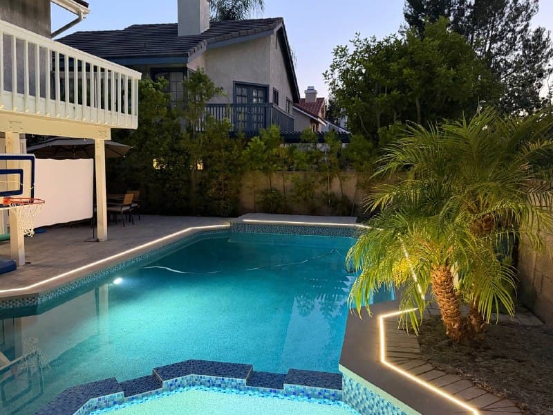 LED strip outlining a residential swimming pool at dusk