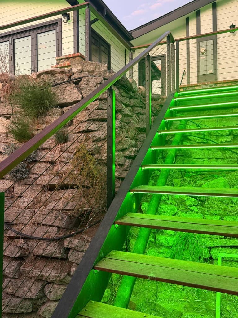 Green LED strips under outdoor wooden stair treads