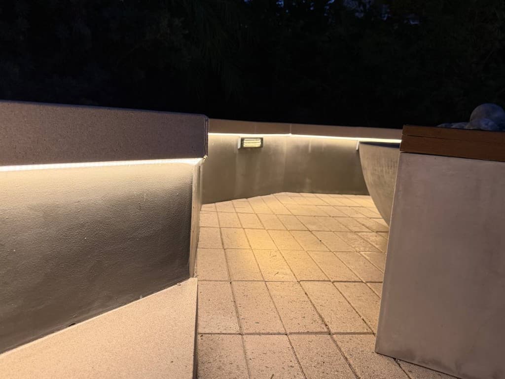 Warm LED wall-wash under a masonry overhang